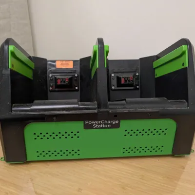 Sale Photo Thumbnail #226: Green and black PowerCharge Station dual battery charger dock, showing some light surface wear.