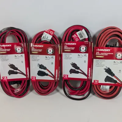 Sale Photo Thumbnail #106: Four Husky 25-foot, 14-gauge indoor/outdoor extension cords in red and black, in original retail packaging.