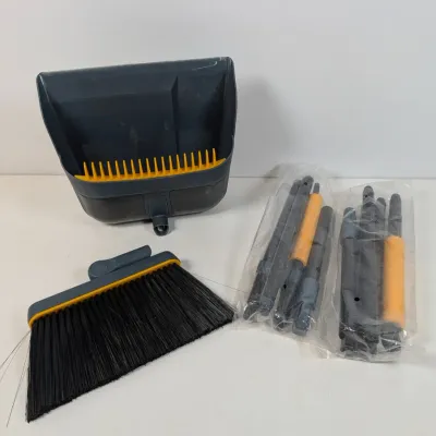 Sale Photo Thumbnail #295: Modern plastic broom and dustpan set with yellow accents, including unassembled handle segments in original plastic packaging.