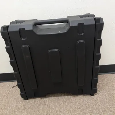 Sale Photo Thumbnail #281: Heavy-duty black molded plastic carrying case with integrated handle, showing minor surface wear.
