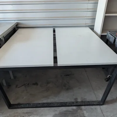 Sale Photo Thumbnail #25: Modern industrial-style desk featuring a black metal frame and a split white laminate top.