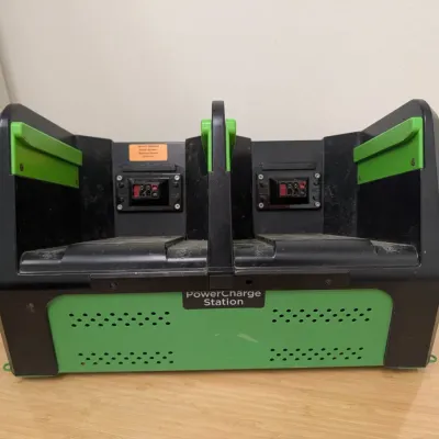 Sale Photo Thumbnail #222: Green and black PowerCharge Station dual battery charger, showing some light dust and wear from use.