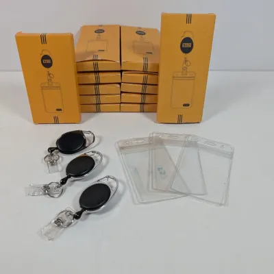 Sale Photo Thumbnail #158: KTRIO retractable badge holders with clear plastic ID sleeves, shown with several new-in-box packages.