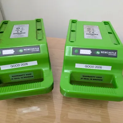 Sale Photo Thumbnail #230: Pair of Newcastle Systems green portable power system batteries, labeled "GOOD 2026" and showing light cosmetic wear.