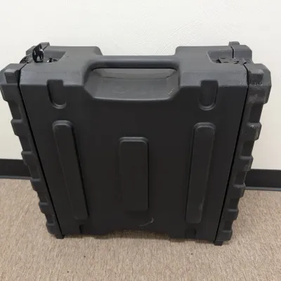 Sale Photo Thumbnail #282: Heavy-duty black molded plastic equipment transit case with integrated carry handle and latch closures.