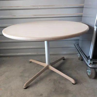 Sale Photo Thumbnail #31: Round laminate-top pedestal table with a four-star metal base, suitable for office or casual dining use.