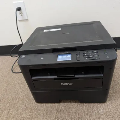 Sale Photo Thumbnail #218: Brother HL-L2395DW monochrome laser printer with flatbed copier and scanner, featuring a color touchscreen display and wireless connectivity.