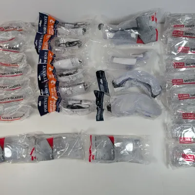 Sale Photo Thumbnail #157: Large assortment of new, individually wrapped safety glasses and goggles from brands including Uline, Portwest, and 3M.
