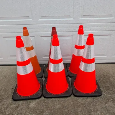 Sale Photo Thumbnail #186: Group of six orange traffic cones with reflective silver bands, showing varying levels of wear.