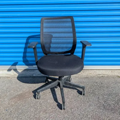 Sale Photo Thumbnail #57: Modern black mesh office chair with adjustable armrests and a five-star rolling base.