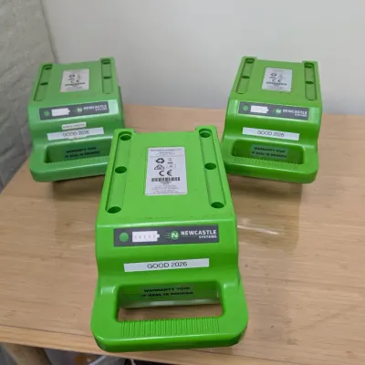 Sale Photo Thumbnail #237: Three Newcastle Systems green industrial power pack batteries, labeled "GOOD 2026," showing some light surface wear.