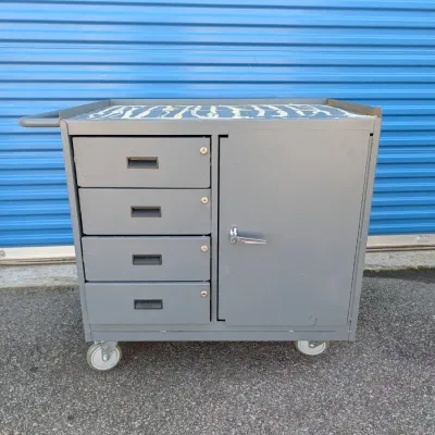 Sale Photo Thumbnail #10: Industrial gray metal rolling tool cart featuring four drawers with recessed pulls and a larger side cabinet with a locking handle.