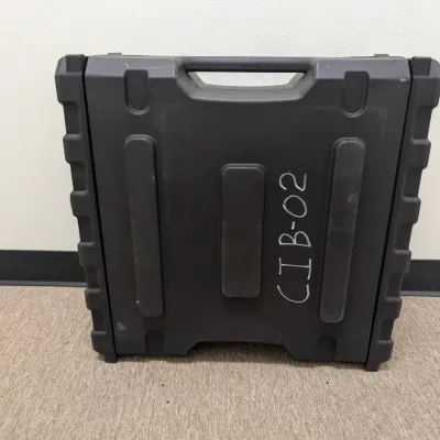 Sale Photo Thumbnail #289: Heavy-duty black molded plastic equipment carrying case with integrated handle, marked with handwritten white lettering 'CIB-02'.