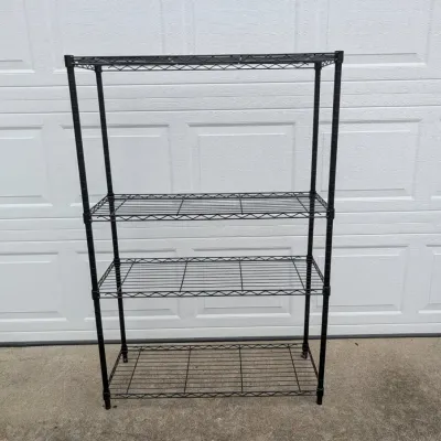 Sale Photo Thumbnail #64: Four-tier black wire shelving unit, suitable for garage or pantry storage.
