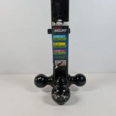 Sale Photo Thumbnail #143: TowSmart tri-ball trailer hitch mount featuring 1-7/8 inch, 2 inch, and 2-5/16 inch black hitch balls, showing some wear and paint chipping from use.