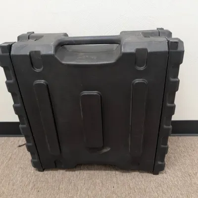 Sale Photo Thumbnail #286: Heavy-duty black molded plastic carrying case with integrated handle, showing some light surface wear.