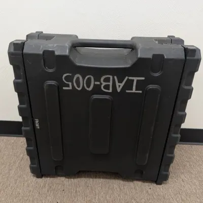 Sale Photo Thumbnail #283: Heavy-duty black molded plastic equipment transit case, marked with 'IAB-005' in white lettering, showing minor scuffs from use.