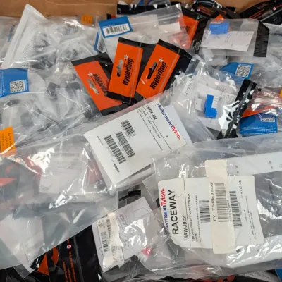 Sale Photo Thumbnail #302: Large assortment of packaged networking and cabling accessories, including HellermannTyton raceway junction boxes and Hyperline components.