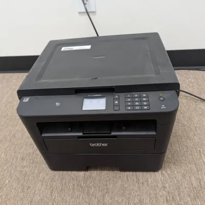 Sale Photo Thumbnail #219: Brother HL-L2395DW monochrome laser printer with flatbed copier and scanner, showing light surface dust.