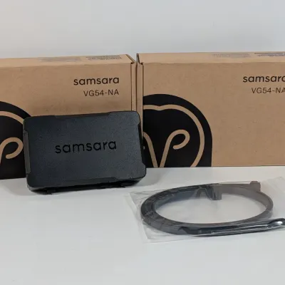 Sale Photo Thumbnail #174: Samsara VG54-NA vehicle gateway device with its original packaging and an included cable in a plastic bag.