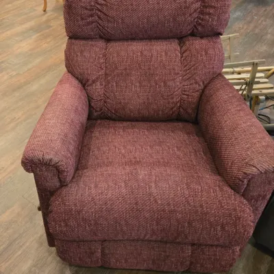 Sale Photo Thumbnail #45: Overstuffed recliner armchair upholstered in a textured mauve fabric, featuring a plush, segmented backrest and rolled armrests.