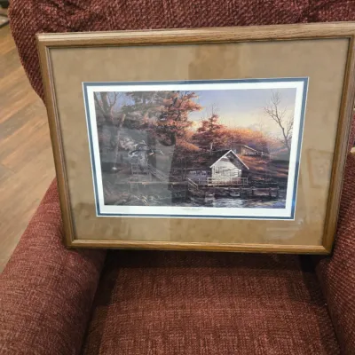 Sale Photo Thumbnail #34: Framed and matted landscape print titled "Autumn Shoreline" by Terry Redlin, depicting a rustic cabin by a lake with ducks in flight, housed in a simple wood frame.