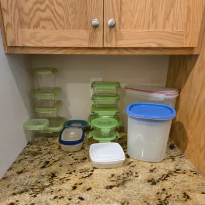 Sale Photo Thumbnail #75: Assortment of plastic food storage containers with lids, including various sizes of Tupperware and Rubbermaid brands.