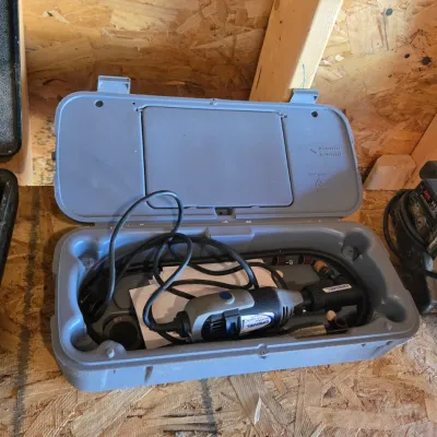 Sale Photo Thumbnail #112: Dremel MultiPro rotary tool with cord, housed in its original grey plastic carrying case.