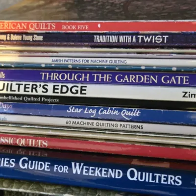 Sale Photo Thumbnail #24: Stack of quilting instruction and pattern books, including titles like "The Thimbleberries Guide for Weekend Quilters" and "The Quilter's Edge."