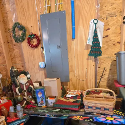 Sale Photo Thumbnail #86: Assorted Christmas decorations and home goods, including a large Santa figurine, a woven basket, holiday linens, and wall hangings.