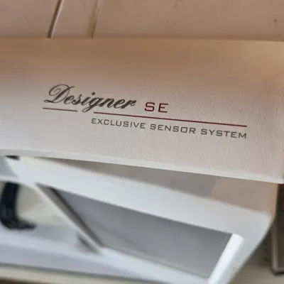 Sale Photo Thumbnail #107: Husqvarna Viking Designer SE sewing and embroidery machine, showing the "Designer SE Exclusive Sensor System" branding on the top lid.