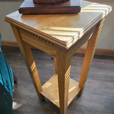 Sale Photo Thumbnail #48: Mission-style oak pedestal table featuring a square top with dentil molding detail and a lower display shelf.