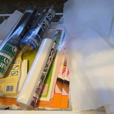 Sale Photo Thumbnail #25: Assorted sewing and embroidery stabilizers, including Sulky brand rolls, organized in a white wire basket.