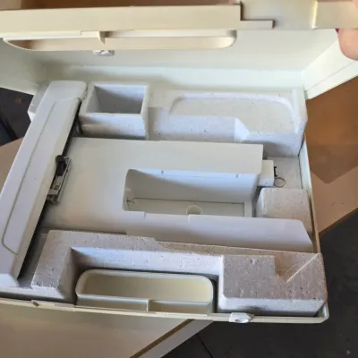 Sale Photo Thumbnail #106: Vintage sewing machine extension table and accessories, housed in their original molded styrofoam packaging inside a hard plastic carrying case.