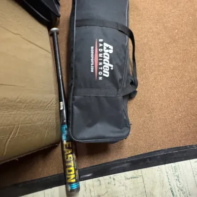 Sale Photo Thumbnail #152: Baden Badminton carrying case alongside a black and yellow Easton baseball bat.