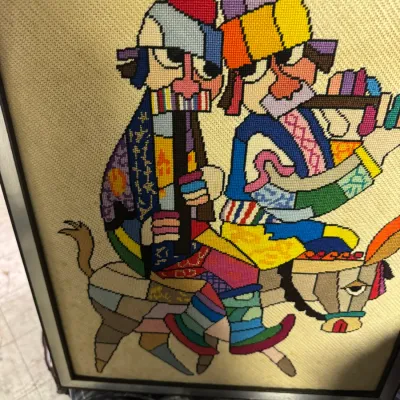 Sale Photo Thumbnail #8: Framed mid-century needlepoint artwork depicting two colorful, stylized figures playing flutes while riding a donkey, in the manner of Alexander Girard.