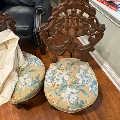 Sale Photo Thumbnail #38: Victorian-style carved wood side chair with an openwork floral back and a padded seat upholstered in a blue and white floral fabric.
