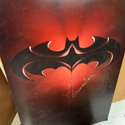 Sale Photo Thumbnail #107: Batman & Robin promotional poster featuring the red bat logo, signed by director Joel Schumacher.