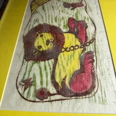 Sale Photo Thumbnail #12: Framed whimsical woodblock print depicting a stylized lion, titled "Mercy Sweet Pussy Cat," featuring vibrant yellow, green, and pink tones on textured paper.