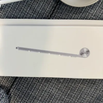 Sale Photo Thumbnail #303: Apple Magic Keyboard in its original white retail packaging, showing the side profile graphic on the box.