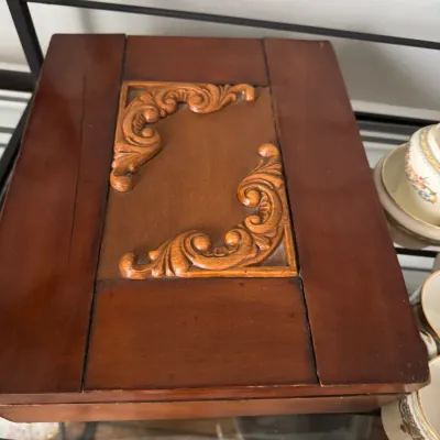 Sale Photo Thumbnail #345: Vintage wooden jewelry or keepsake box featuring a hinged lid with carved scrollwork details in a contrasting lighter wood tone.