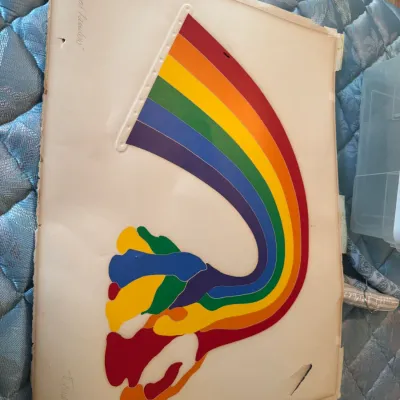 Sale Photo Thumbnail #206: Vintage limited edition embossed serigraph print featuring a stylized rainbow design, signed and numbered 2/100, showing some wear and a small tear on the bottom right corner.