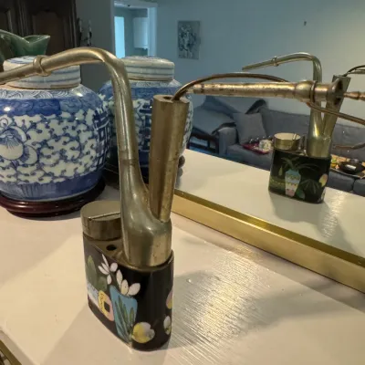 Sale Photo Thumbnail #60: Vintage Chinese cloisonné water pipe with a black ground, floral motifs, and brass components, shown in front of a mirror.