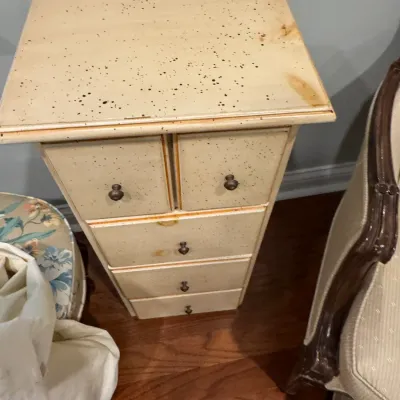 Sale Photo Thumbnail #24: Country-style cream-painted wooden lingerie chest featuring a speckled finish, five drawers with small metal pulls, and light distressing.