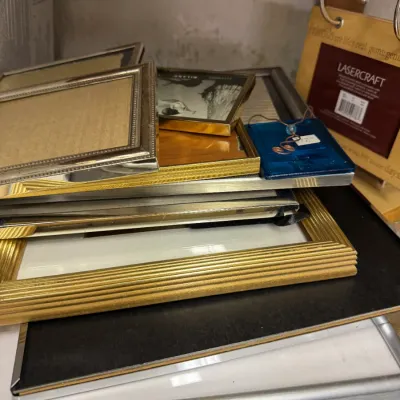 Sale Photo Thumbnail #84: Assorted collection of vintage picture frames in various sizes, featuring gold-toned, silver-toned, and wood finishes.