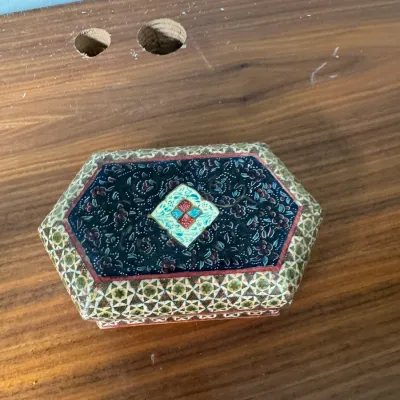 Sale Photo Thumbnail #286: Persian Khatamkari inlaid wooden box, featuring a hand-painted miniature scene on the lid surrounded by intricate geometric micro-mosaic work.
