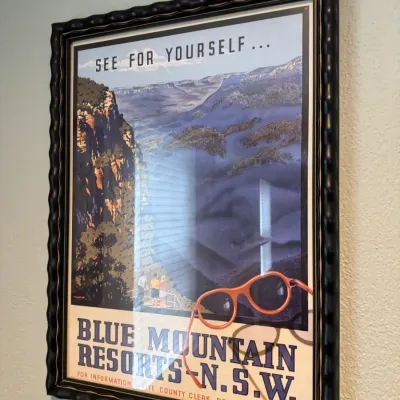 Sale Photo Thumbnail #271: Vintage-style travel poster advertising Blue Mountain Resorts in New South Wales, Australia, presented in a dark, wavy-textured frame.