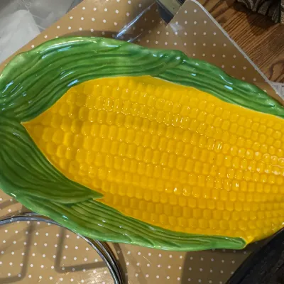 Sale Photo Thumbnail #306: Vintage ceramic corn on the cob serving platter, featuring a glossy yellow kernel design cradled by green husks.