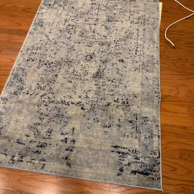 Sale Photo Thumbnail #18: Modern distressed-style area rug in shades of gray and navy blue, displayed on a hardwood floor.
