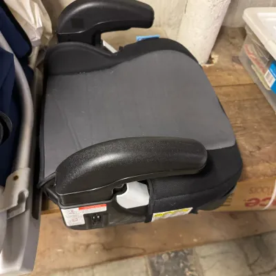 Sale Photo Thumbnail #85: Backless booster car seat in black and grey fabric with integrated armrests, showing light wear.